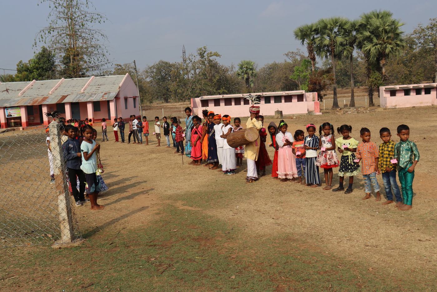 Children lined up across the field at a centre